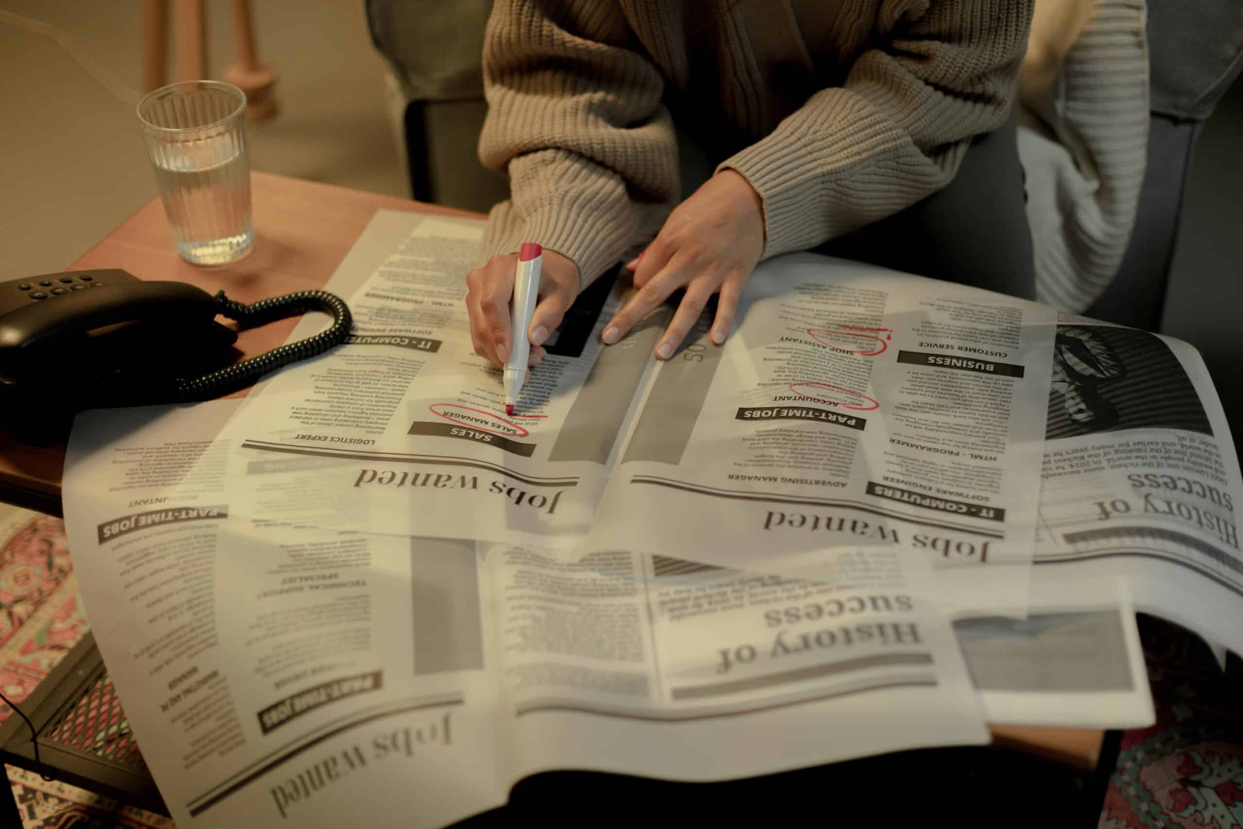 woman searching job in newspaper