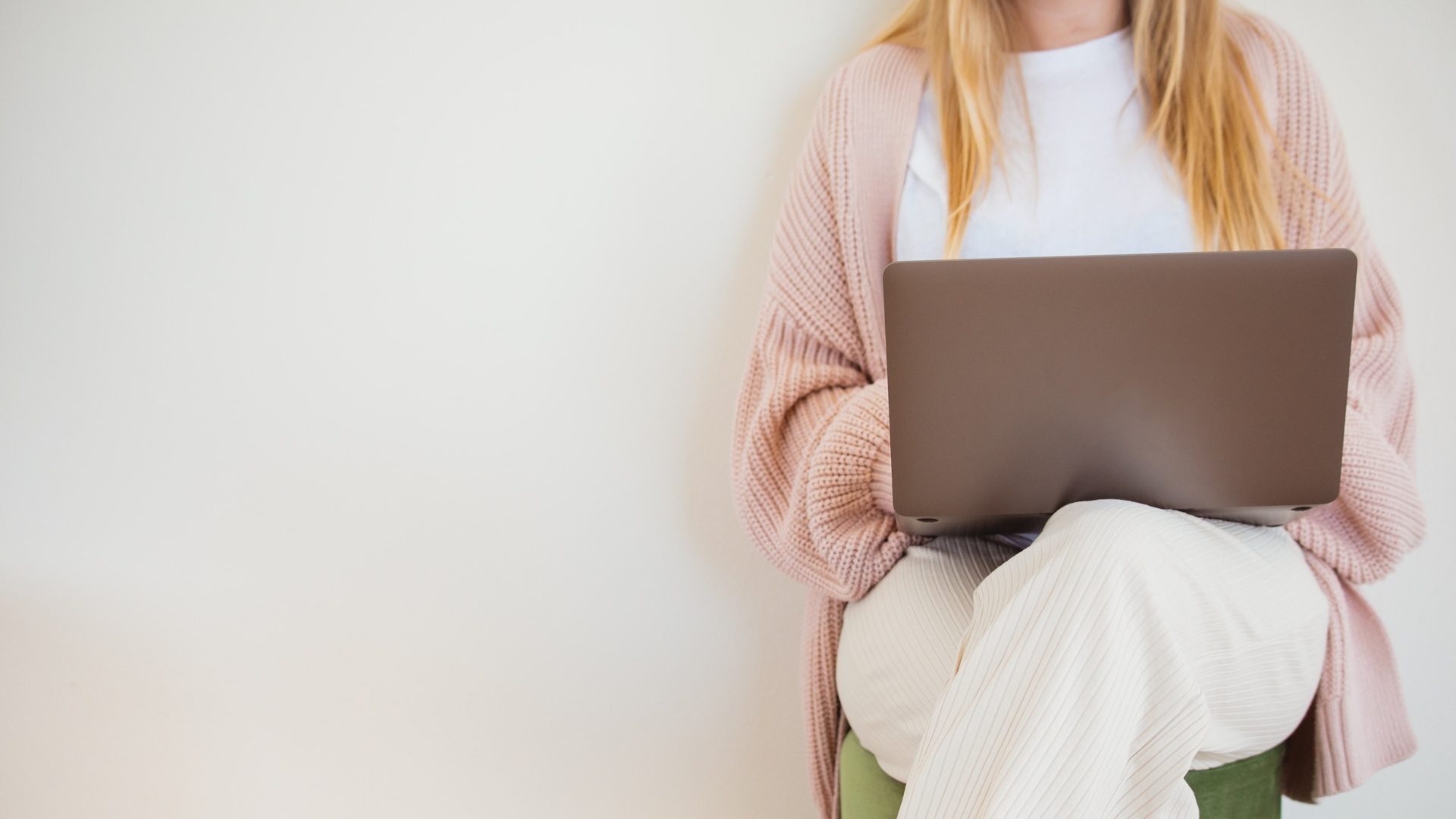 a woman in white clothes sitting with a laptop jobs for people with anxiety